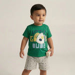 Child wearing a green t-shirt with a graphic design and text, standing against a plain background